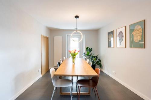 a dining room with a wooden table and chairs at Camere d'Aria in Locana
