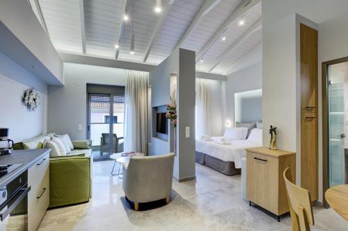 a bedroom with a bed and a living room at Carabella Residence in Lefkada Town