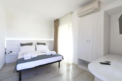 Postel nebo postele na pokoji v ubytování L' Arcobaleno Resort