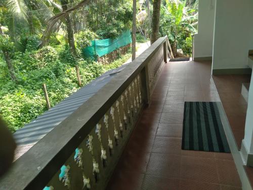 a walkway in a building with a view of a forest at Homely Home stay in Kalpetta