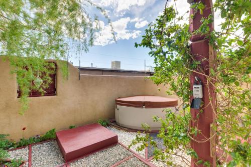 a bath tub sitting on the side of a building at Adobe Escape with Hot Tub and Art for Sale! in El Prado