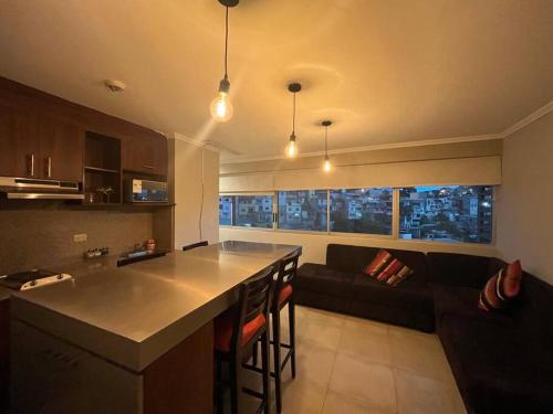 a kitchen and a living room with a couch at Suite en Puerto Santa Ana! in Guayaquil