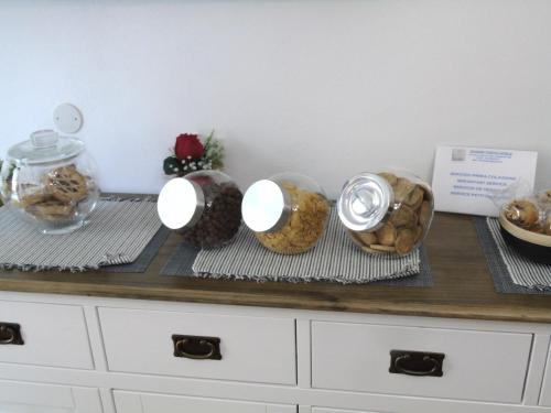 a counter with four bowls of food on it at Casa Vacanza LiHele - Locazione Turistica in Castelsardo