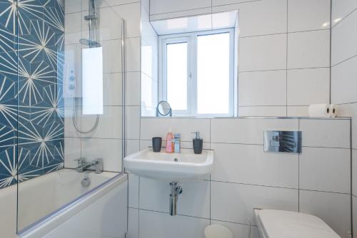 a white bathroom with a sink and a toilet at No 205 in Doncaster