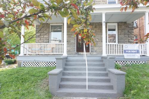 a house with stairs in front of it at Charming Victorian Home In Historic District in Newburgh
