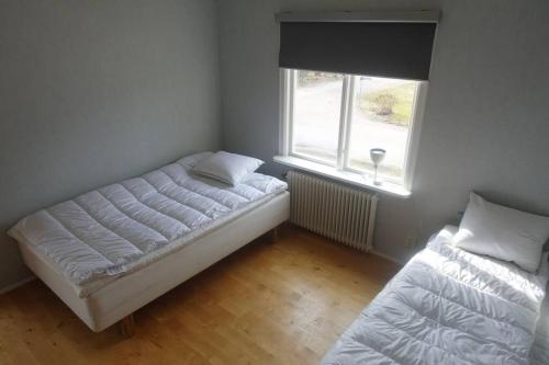 a bedroom with two beds and a window at Space to socialize 3km from the peak of Isaberg! in Hestra