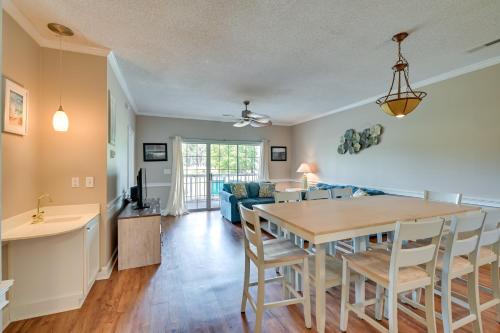 a kitchen and living room with a table and chairs at Golf, Swim and Unwind at Bright Myrtle Beach Condo! in Myrtle Beach