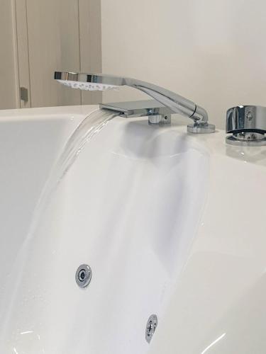 a bath tub with a faucet on top of it at Muricis in Santeramo in Colle