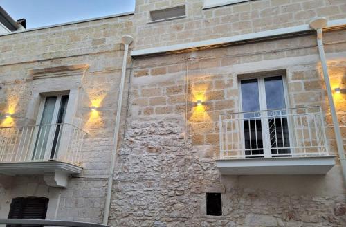 a stone building with lights on the side of it at Muricis in Santeramo in Colle