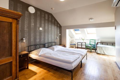 a bedroom with a bed and a dining room at Sir Toby's Hostel in Prague