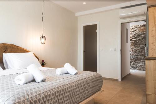 a bedroom with a bed with two pillows on it at Magic View Suites Mykonos in Mýkonos City