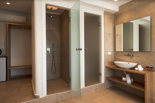 a bathroom with a shower and a sink at Magic View Suites Mykonos in Mýkonos City