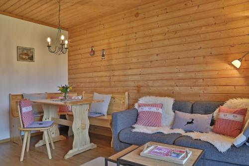 a living room with a couch and a table at Landhaus Barbara in Kitzbühel