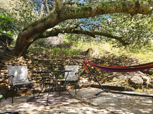 two chairs and a hammock under a tree at Oak Hill Inn in Julian