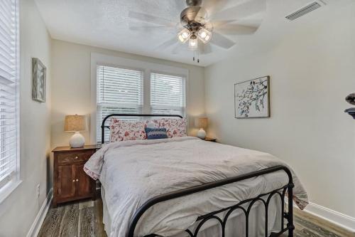 a bedroom with a bed and a ceiling fan at Beautiful Stylish Home in Avondale Jacksonville in Jacksonville