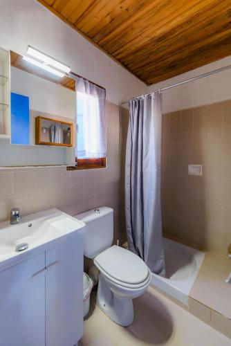 a bathroom with a toilet and a sink and a shower at Résidence Itylon in Cargèse