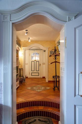a hallway of a home with a door and a staircase at Inselhotel Arfsten in Wyk auf Föhr