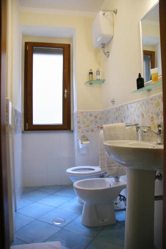 a bathroom with a toilet and a sink at Residenza D'epoca Tamara in Castellabate