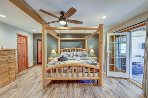 a bedroom with a wooden bed and a ceiling fan at Great Salida Getaway - 20 minutes to Monarch with Spa & Gameroom in Salida