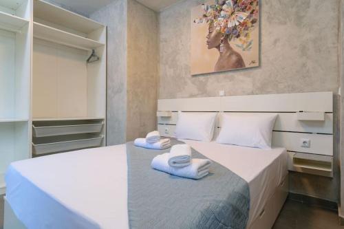 a bedroom with two beds with towels on them at Konstantinos , luxury maisonette in Chania in Mourniaí