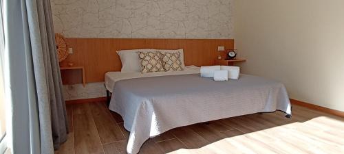 a bedroom with a bed with two pillows on it at Casa da Naia in Braga