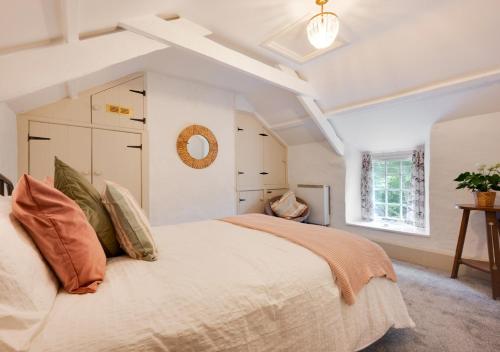 a bedroom with a large bed and a window at Riverside in Saint Breward