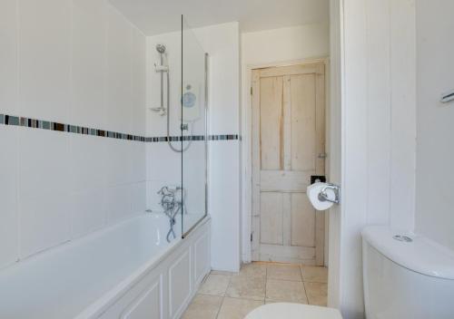 a bathroom with a shower and a toilet at Stargazy in Mousehole