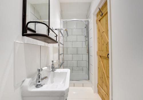 a bathroom with a sink and a shower at The Byre - Sennen in Sennen