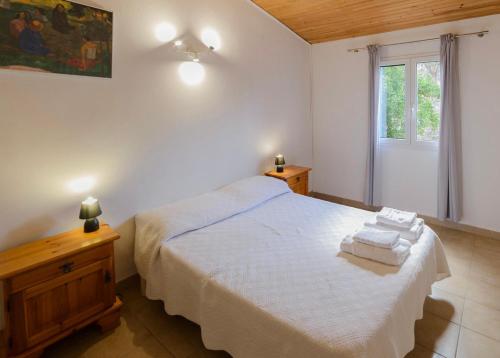 a bedroom with a bed with towels on it at Résidence Itylon in Cargèse