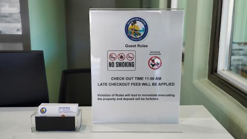 a sign for a no smoking sign on a table at SeaSide Inn & Suites in Santa Cruz