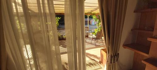a sliding glass door with a view of a patio at Willy's Country Club Cauquenes in De Cauquenes