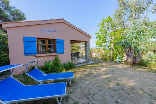 a house with blue stairs in front of it at Résidence Itylon in Cargèse