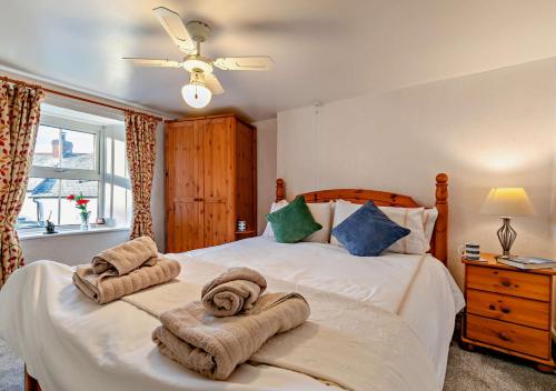 a bedroom with a bed with towels on it at Victoria House - St Issey in Saint Issey