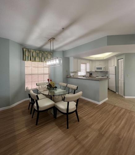 a kitchen and dining room with a table and chairs at Star Island Resort and Club - Near Disney in Kissimmee