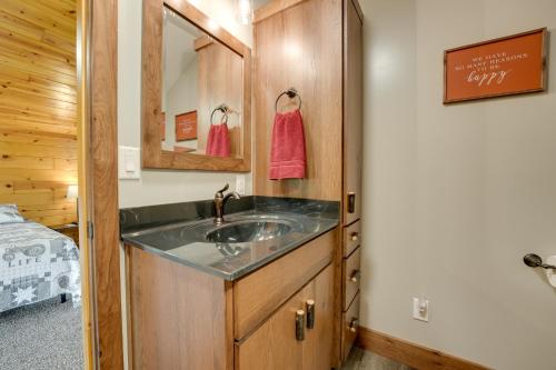 a bathroom with a sink and a mirror at Cozy Haven of Rest Home with Amish Country Views! in Shipshewana