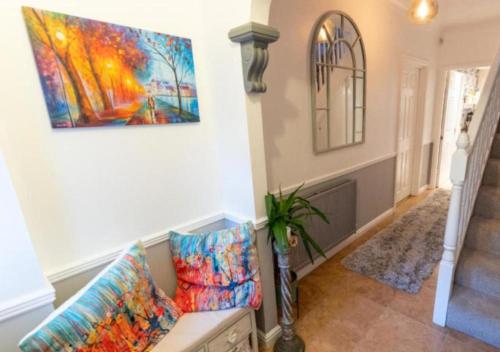 a living room with a couch and a painting on the wall at Cosy Garden Flat, Private Hot Tub & Four Poster Bed in York