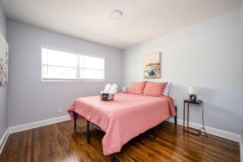 a bedroom with a bed with a pink bedspread at NEW Spacious Decatur Oasis w Fire Pit, Mins to ATL in Decatur