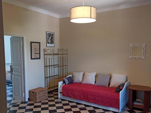 a living room with a red couch in a room at Chez Laurette Murato in Murato