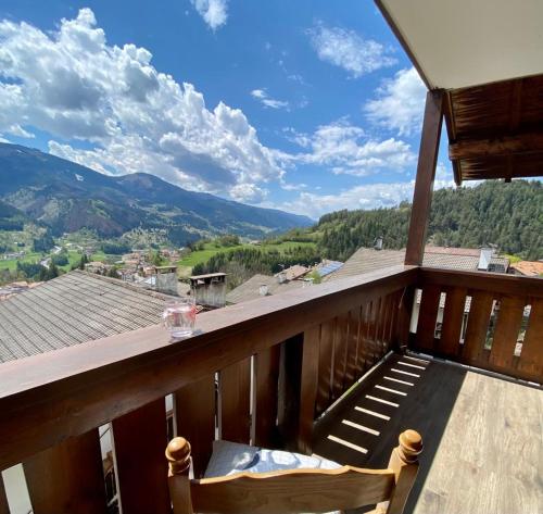 a balcony with a view of the mountains at mountain house the deer in Tesero