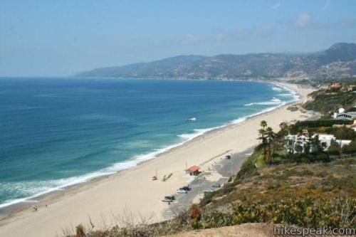 a view of a beach with cars and the ocean at 30 PCT OFF! Malibu Charming Suite, Ocean View, King Bed in Malibu