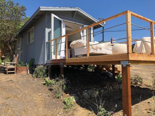 a small house with a bed on a deck at 30 PCT OFF! Malibu Charming Suite, Ocean View, King Bed in Malibu