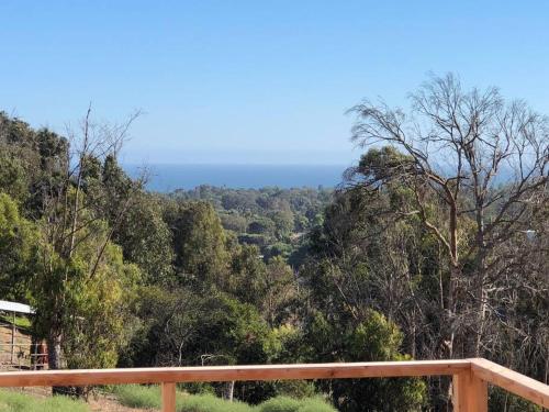 a view of the forest from the balcony of a house at 30 PCT OFF! Malibu Charming Suite, Ocean View, King Bed in Malibu