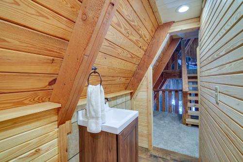 a bathroom with a sink in a log cabin at Lakefront A-Frame Cabin with Community Perks in Columbia