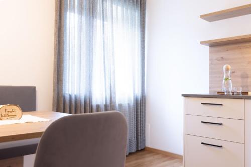 a room with a desk and a chair next to a window at Residence Walchhof in Schenna