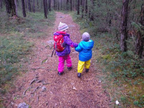 two children walking on a trail in the woods at Apartement Gute Laune in Mieming