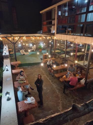 a group of people sitting around a patio at night at Cabinas Vista Al Golfo in Monteverde Costa Rica
