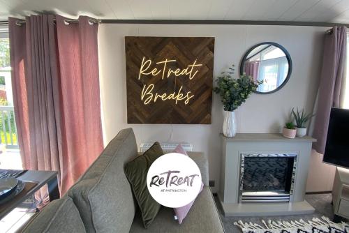 a living room with a couch and a fireplace at ReTreat Breaks - 47 Park Lane in Patrington