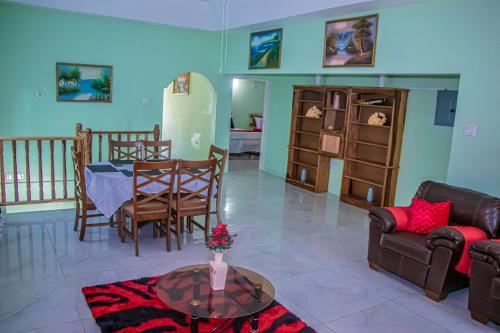 a living room with a table and a couch at The Hamilton's Nature Villa in Clarks Town