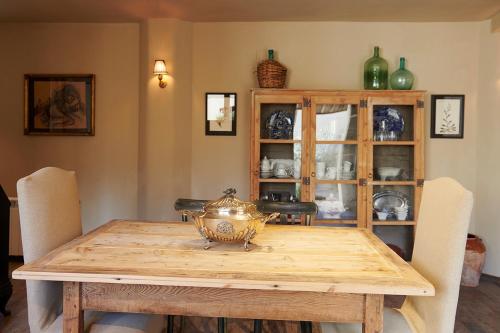 a dining room table with a china cabinet at Casa Rural Sullà in Tremp