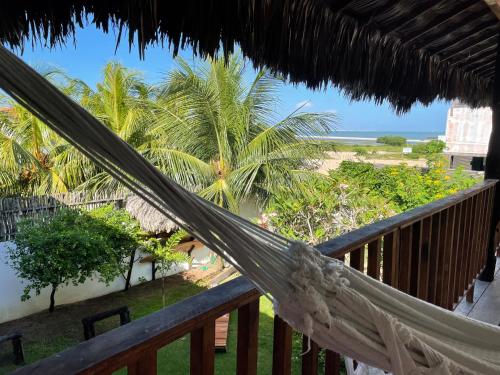a hammock on the balcony of a resort at Casa da Gwen in Jericoacoara